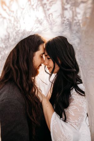 Close-up romantic couple portrait with a soft, backlit background by Branson photographer L. Ballenger Photography.