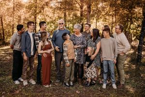Extended family reunion portrait with 10+ people in the Branson Ozarks during an autumn photoshoot.