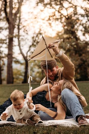 Playful family photo session in Branson featuring a handmade kite and lifestyle photography.