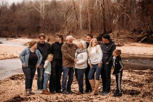 Multi-generational family group posing by the rocky creek bed in a Branson MO wilderness area.