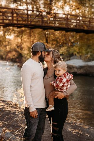 Couple posing under a wooden bridge at Lakeside Forest Wilderness Area in Branson, MO.