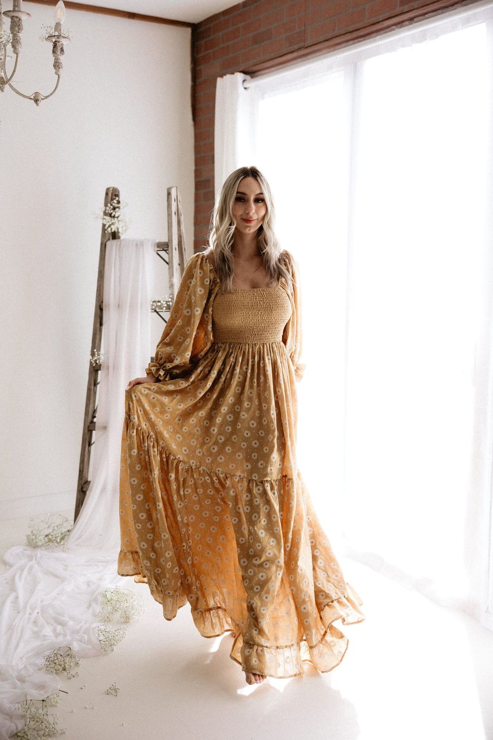 A flowy golden dress with lace details and bell sleeves photographed in multiple angles against a white background.