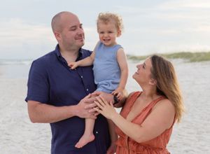 A young family loves on each other in Gulf Shores