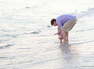 A father plays with his daughter in the water in Pensacola, FL