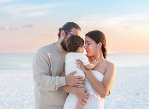 A hispanic family on a white sand beach at sunset in Pensacola Beach family photographer, pensacola beach sunset photography