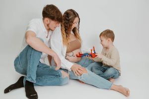 Family moment captured during candid playtime on studio floor.
