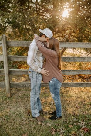 Romantic sunset photo by wooden fence in autumn setting.
