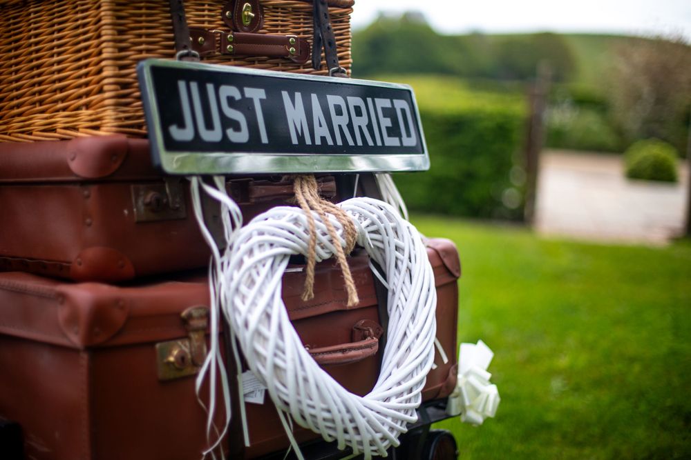 Close up shot of retro luggage with a Just Married sign