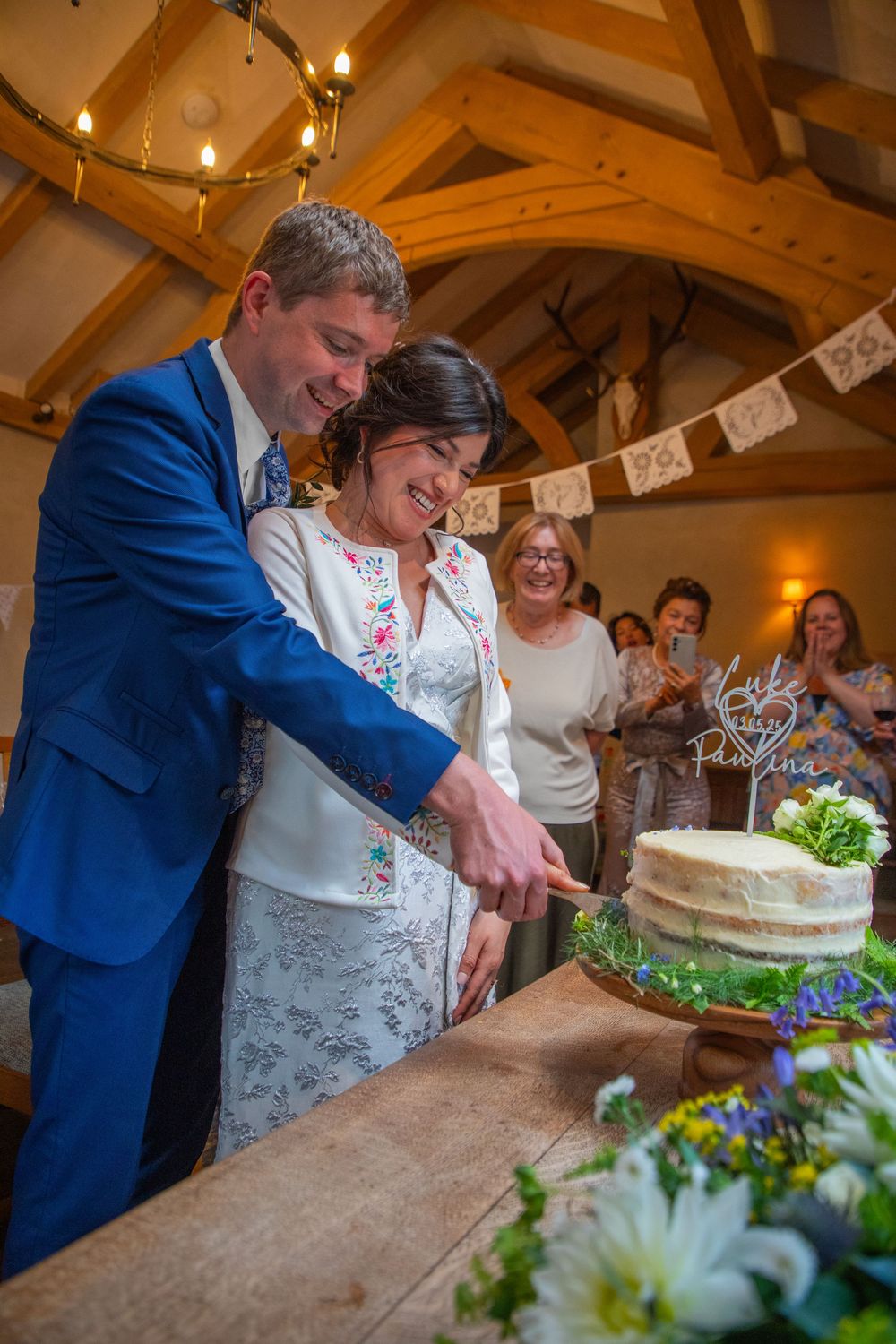 Bride and groom cutting cake at Church House Inn, Rattery, Devon