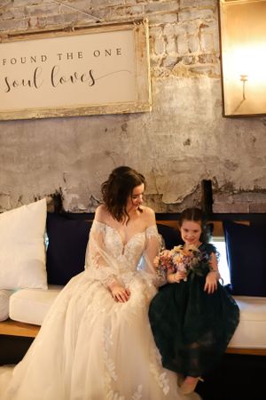 bride and flower girl laughing