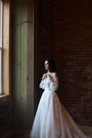 bridal portrait in brick building with low light and soft light