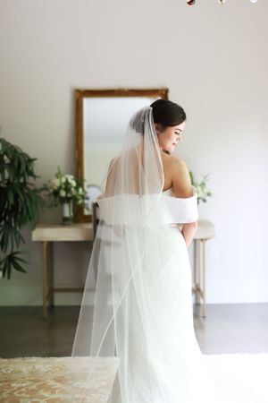 bride smiling portrait with back of veil detail shot