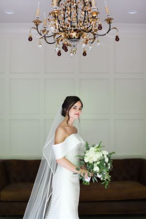 beautiful smiling bride portrait with chandelier