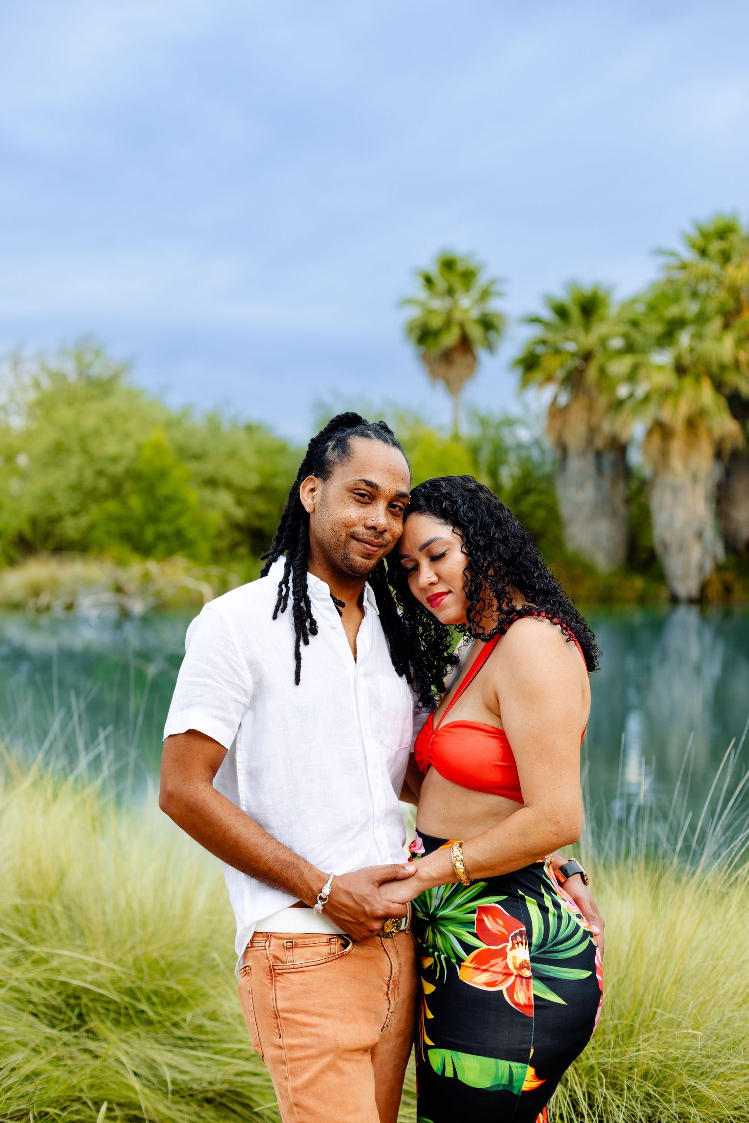 Beautiful tropical portrait with palm trees and ornamental grass in a desert garden setting.