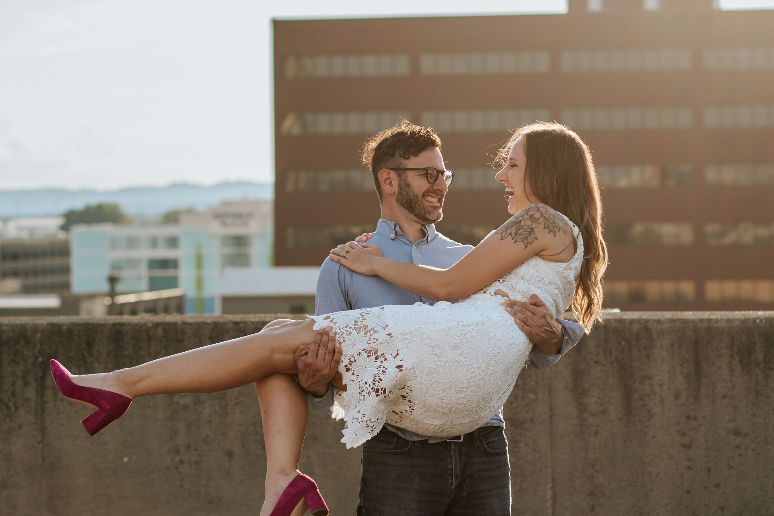 Romantic sunset wedding photo session with couple dancing and dipping on a rooftop terrace.