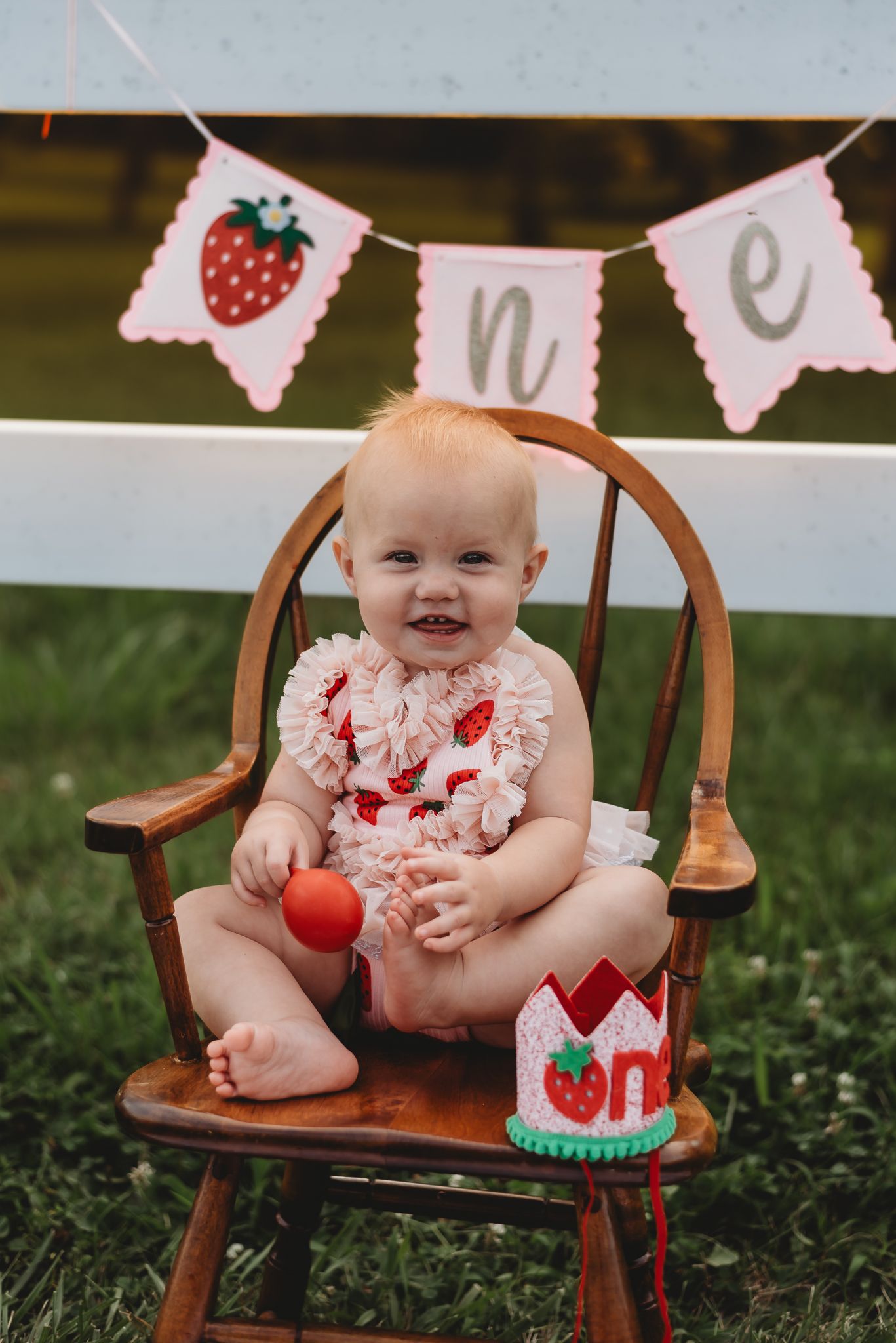 happy toddler under a "ONE" banner