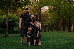 family all in black surrounding by greenery