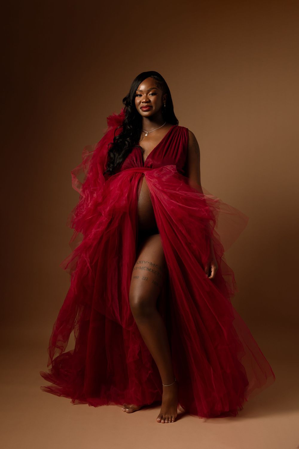 Artistic portrait series featuring flowing red tulle fabric against warm brown backdrop creating dramatic movement and texture.
