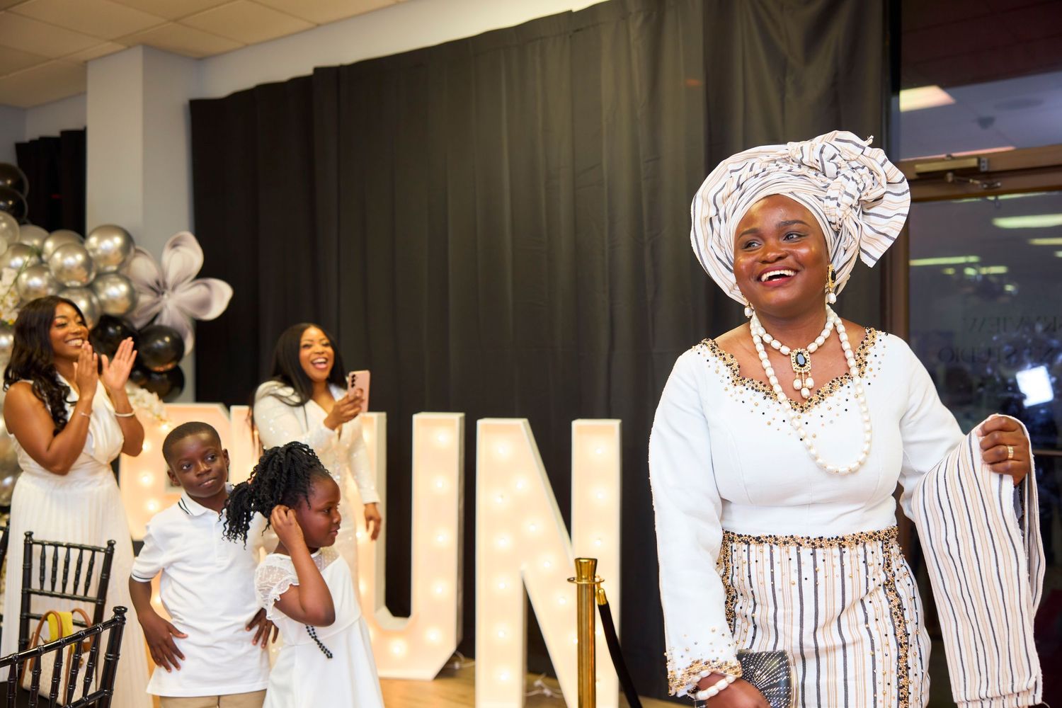 A collection of candid moments at a wedding celebration showing people in white attire dancing and celebrating.