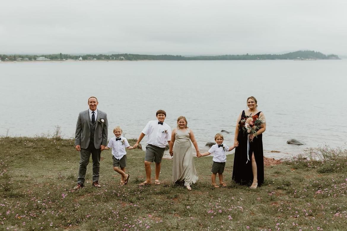 family portrait of Brooke and her family by the lake during their 10-year vow renewal.