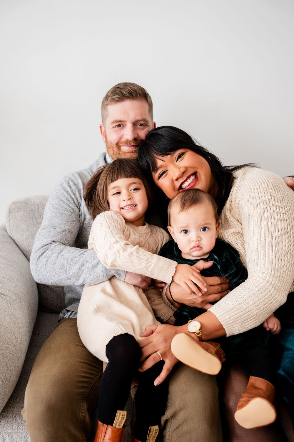 A family shares joyful moments together on a couch in a series of candid lifestyle photos.