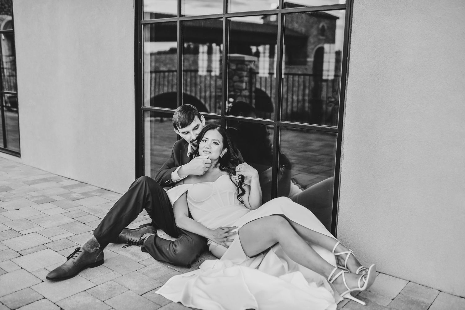 Sunset engagement photography with warm Texas light illuminating the couple and stone venue
