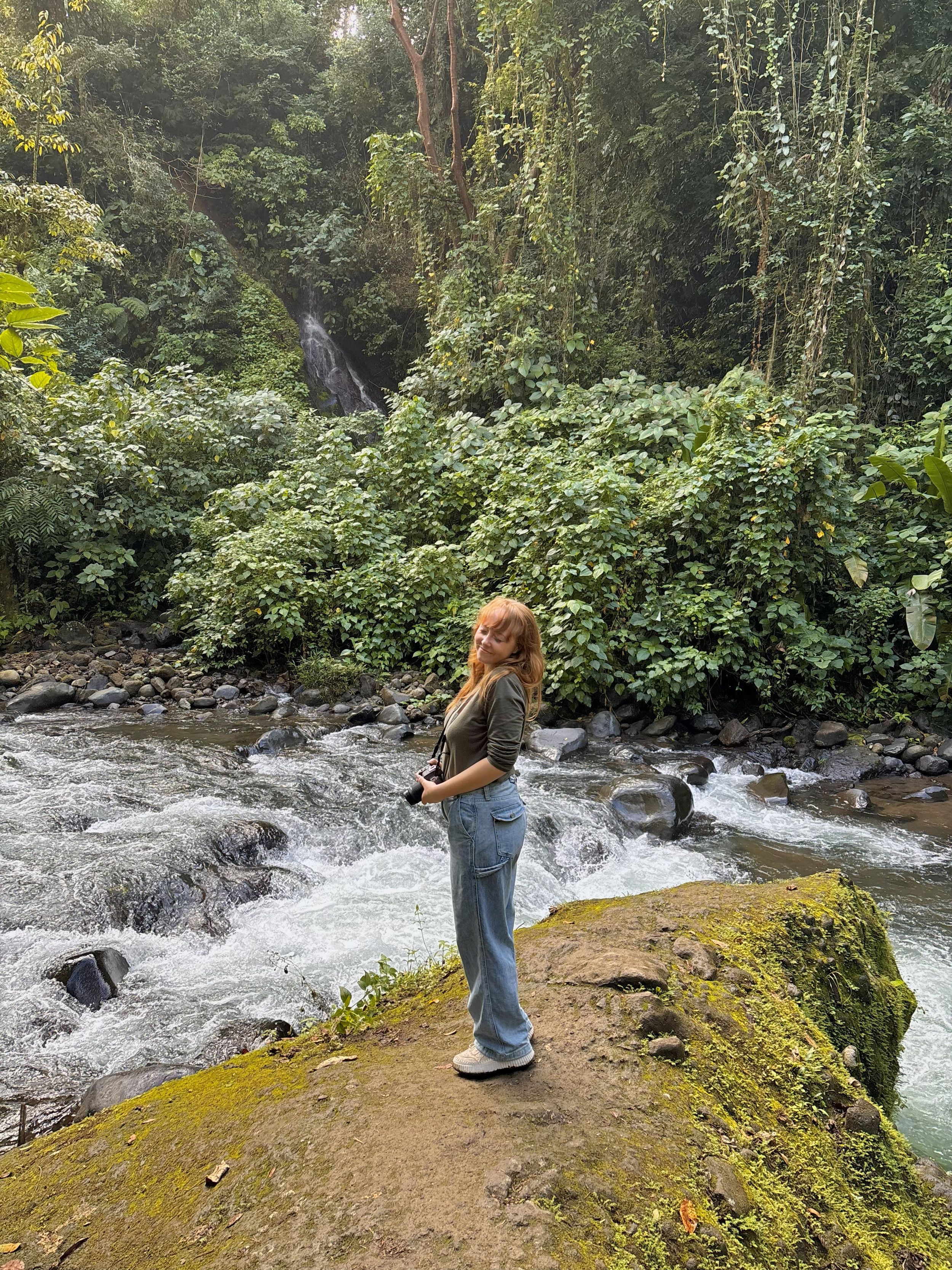 Elise Christensen standing in front of a waterfall in Costa Rica