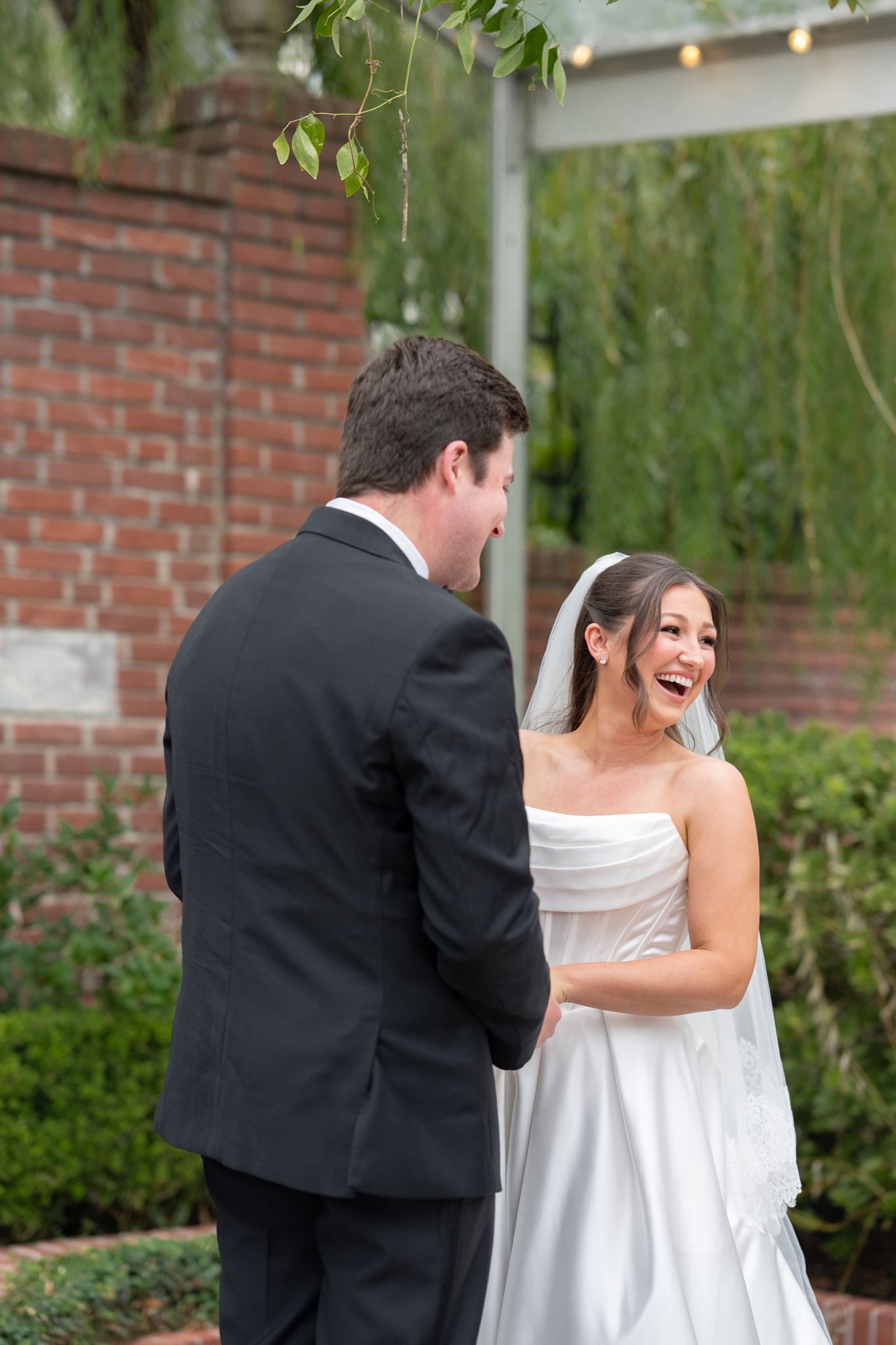 Bride and groom laughing at the alter.