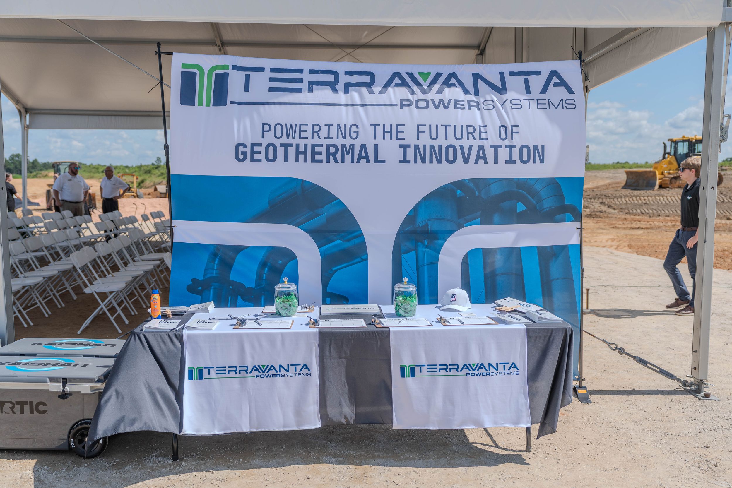 Terravanta Power Systems geothermal innovation booth with branded banner and table display at an outdoor groundbreaking event.