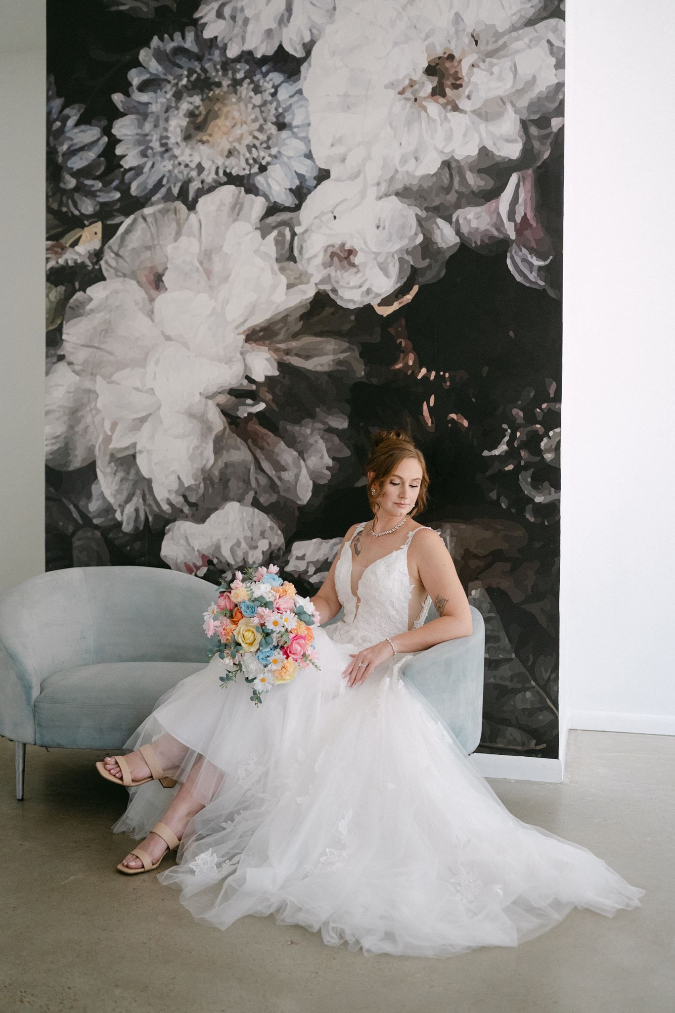 Bride sitting on a blue sofa at Oak Atelier in Conroe Texas.