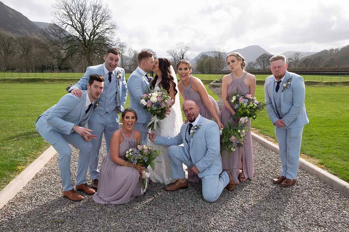Wedding party poses outdoors at New House Farm Cockermouths premier wedding venue Lake District