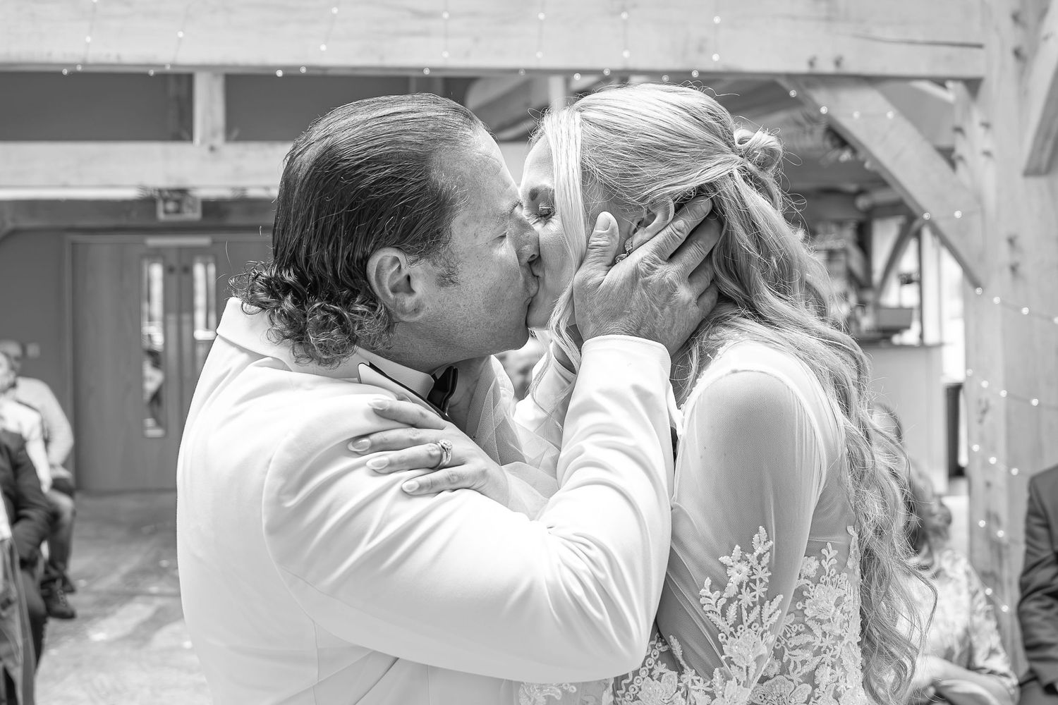 Black and white photo of a couple sharing their first kiss at the altar during their wedding ceremony.Yorkshire, Sheffield, Lincolnshire, UK
