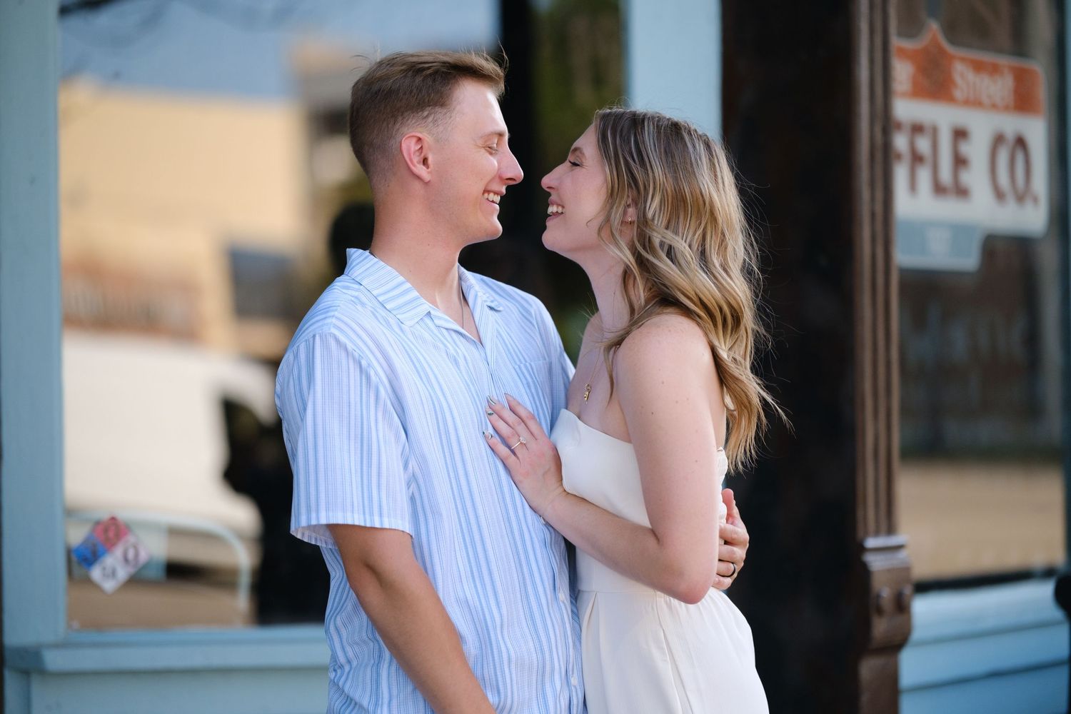 Happy couple sharing a tender moment outside a waffle shop in summer  in Belton Texas