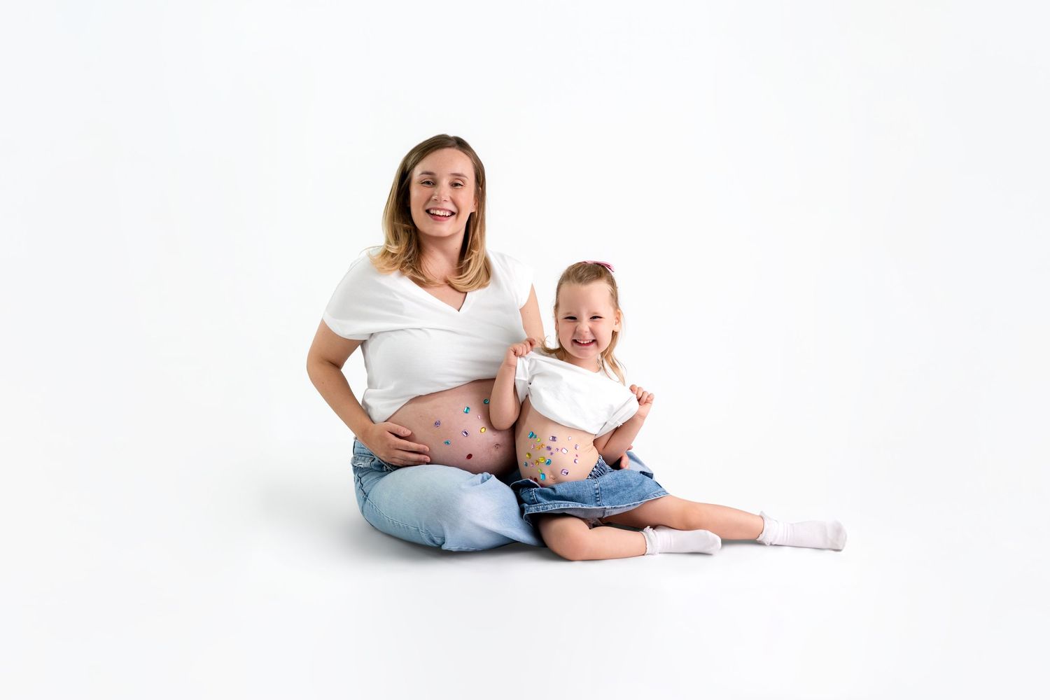 A series of artistic maternity photos showing a pregnant woman's silhouette against a dark background.