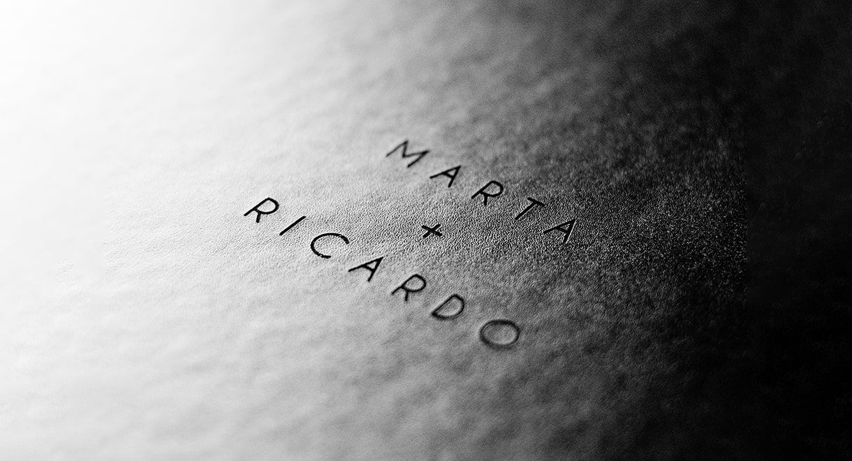 Embossed text on textured paper surface showing raised lettering detail.