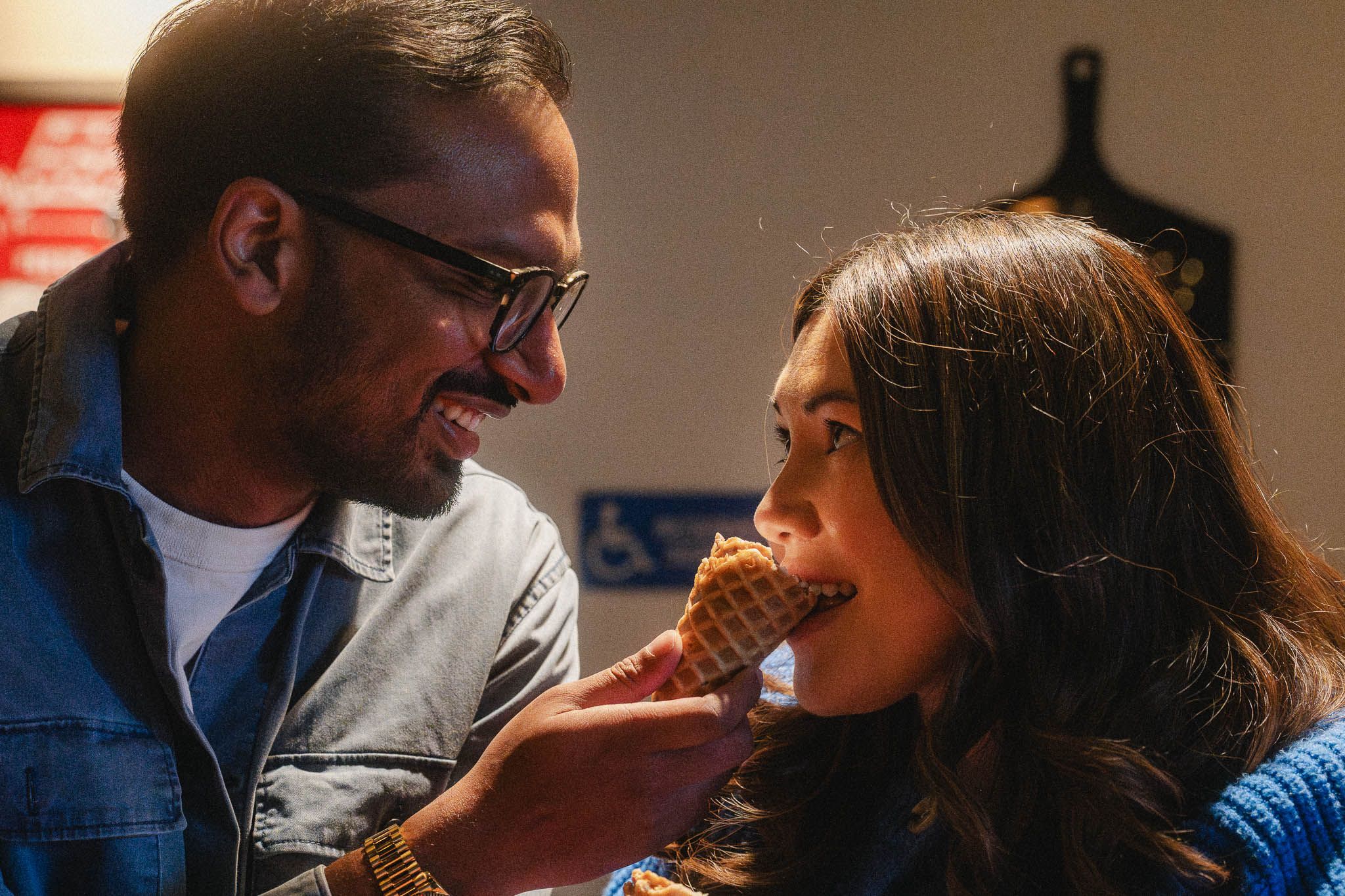 Rohan offering Amanda a bite of ice cream during their playful Pasadena maternity shoot