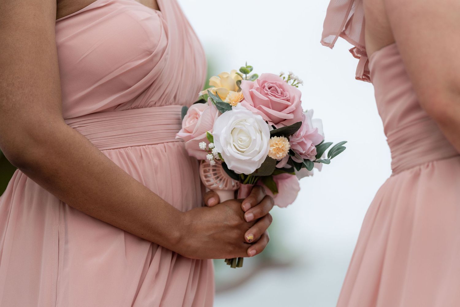 Bridesmaid holding a blush and cream bouquet at a Mansion at Tuckahoe wedding