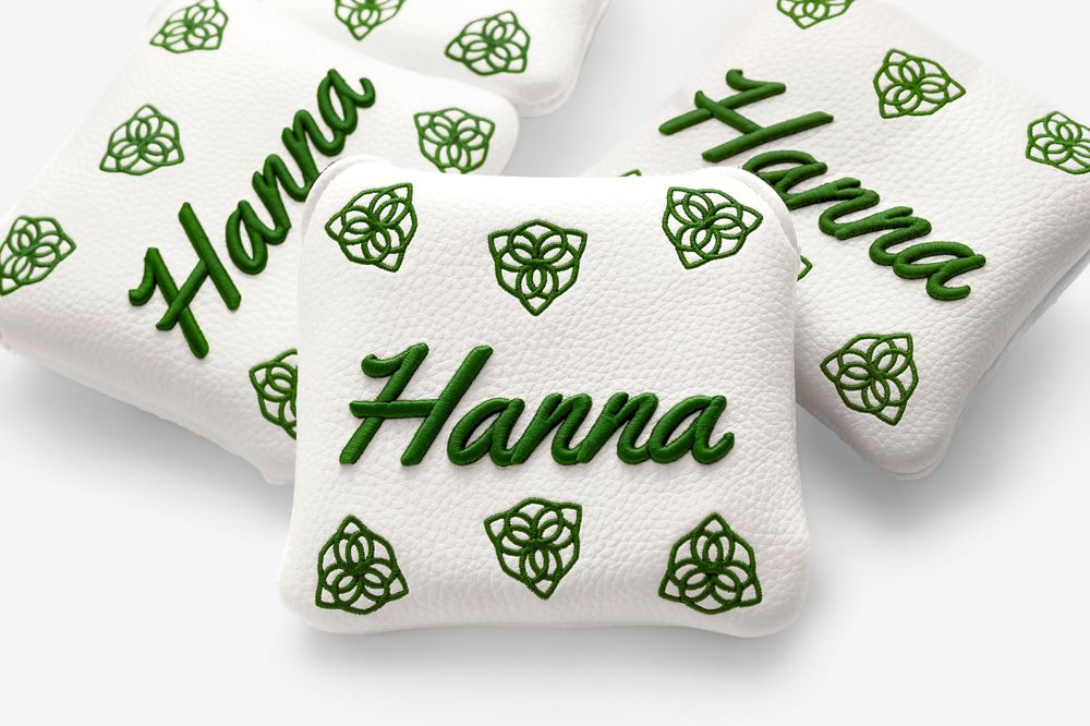 White golf bag accessories with green Celtic knot pattern and personalized Hanna embroidery in hunter green script.