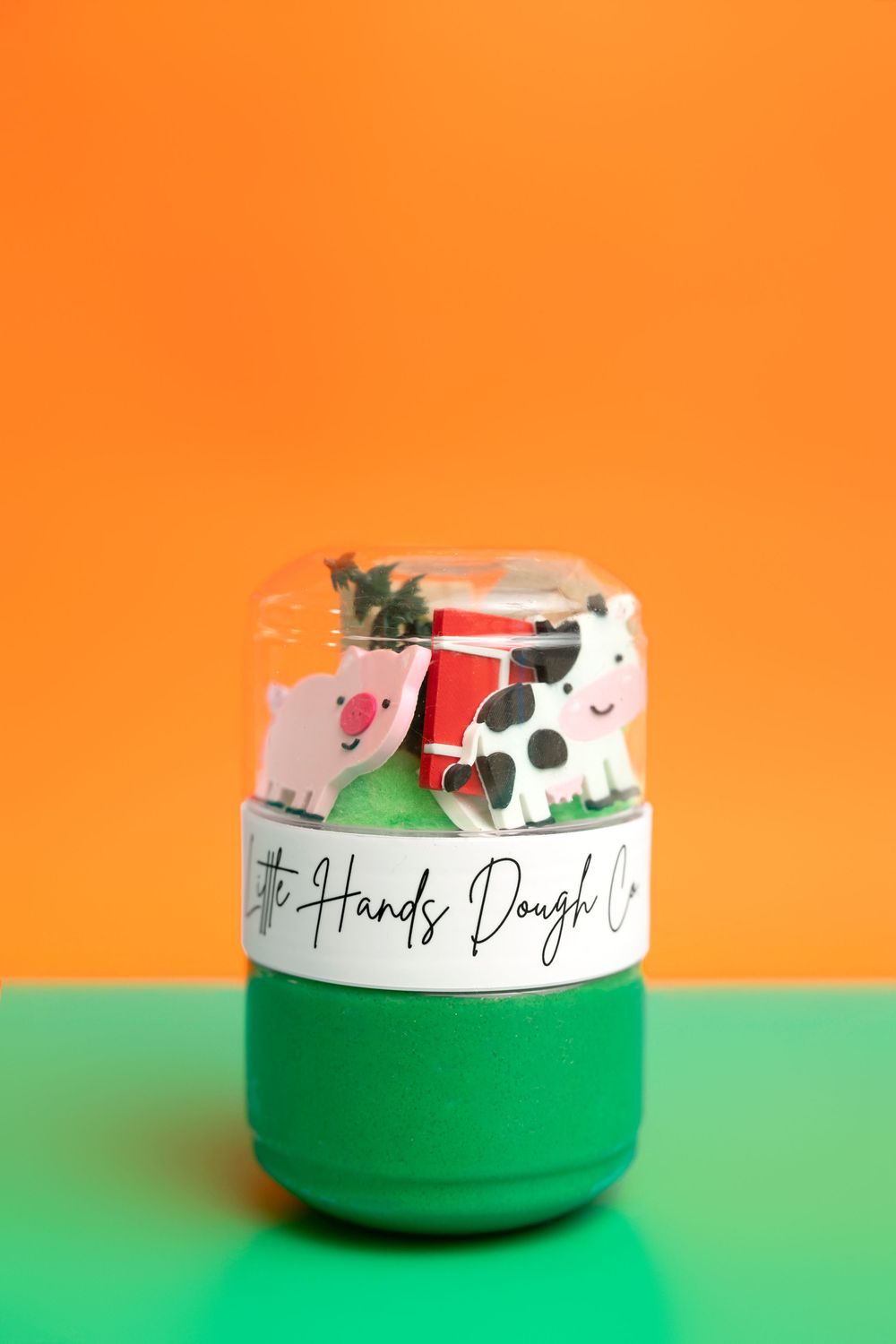 Little Hands Dough Co. farm-themed play dough kit in green jar with pig, cow, and barn cookie cutters.