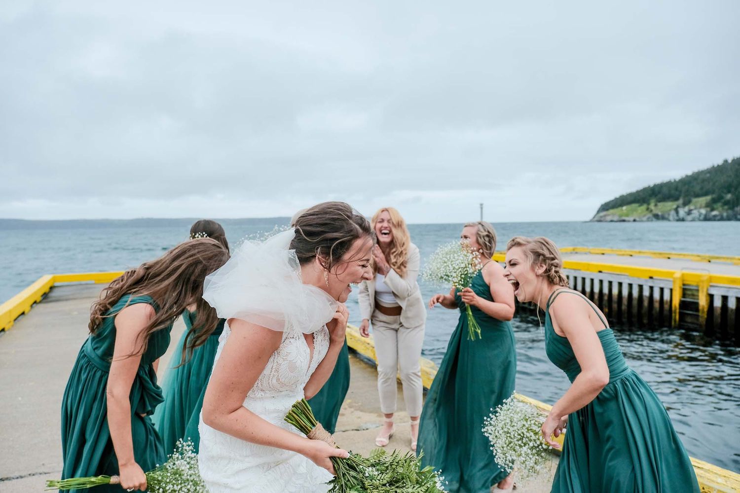 Bride and wedding party dancing and having fun at the beach, captured by the best wedding photographer.