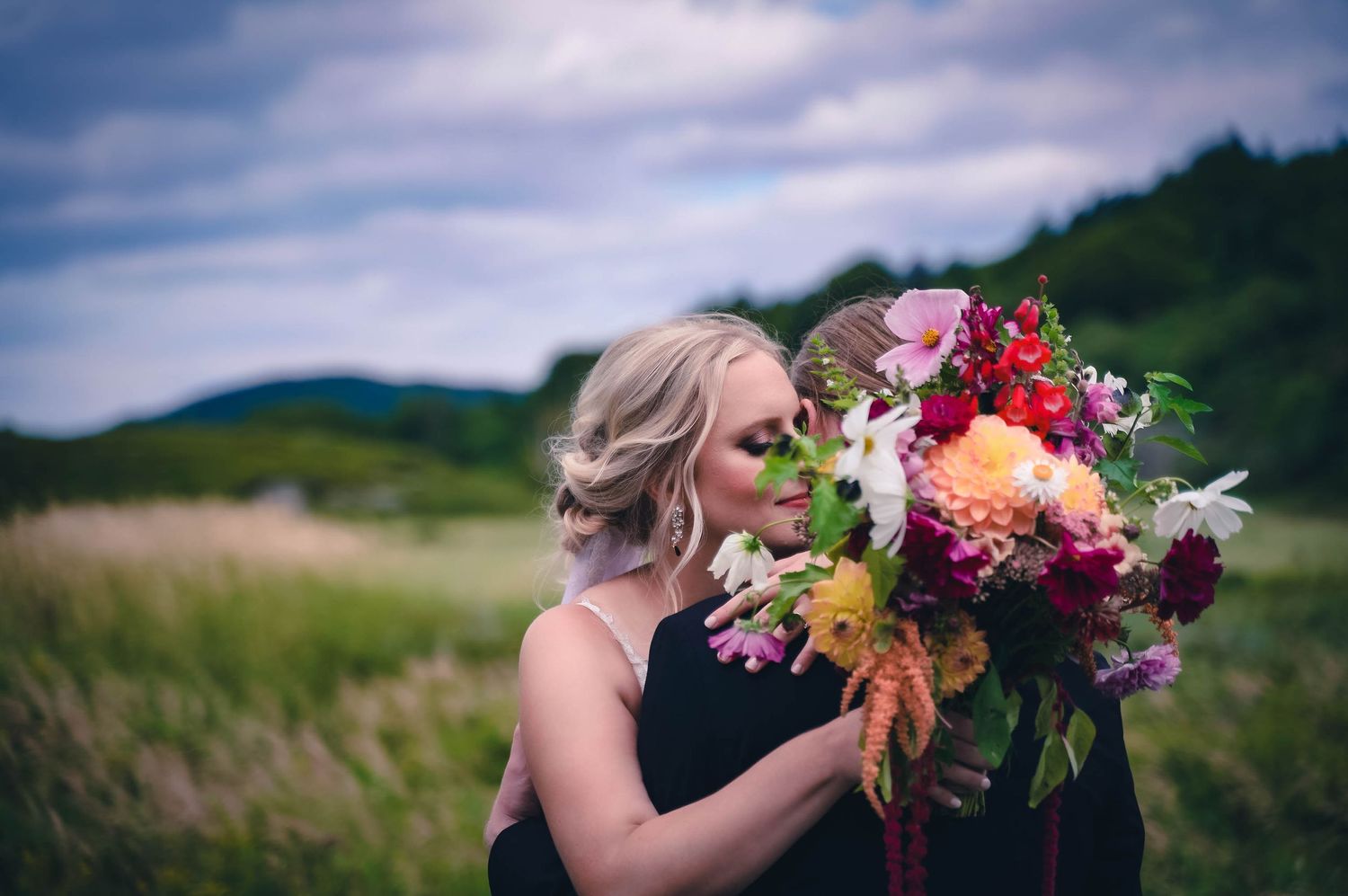 Newly married couple, with the bride holding a unique DIY bouquet made from her garden. best idea