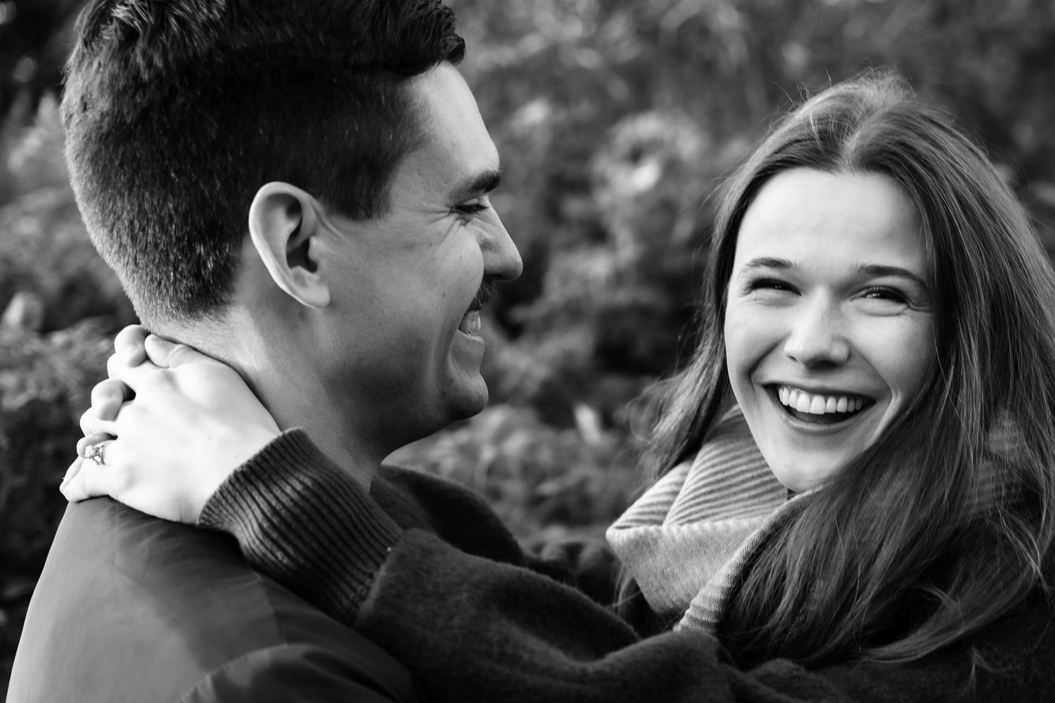 Black and white photo of a couple smiling and posing at their wedding photographer in St. John's, Newfoundland