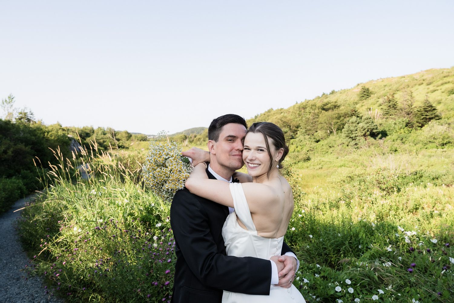 bride hugs her groom saying this is my man from now on taken in St. John's, Newfoundland wedding.
