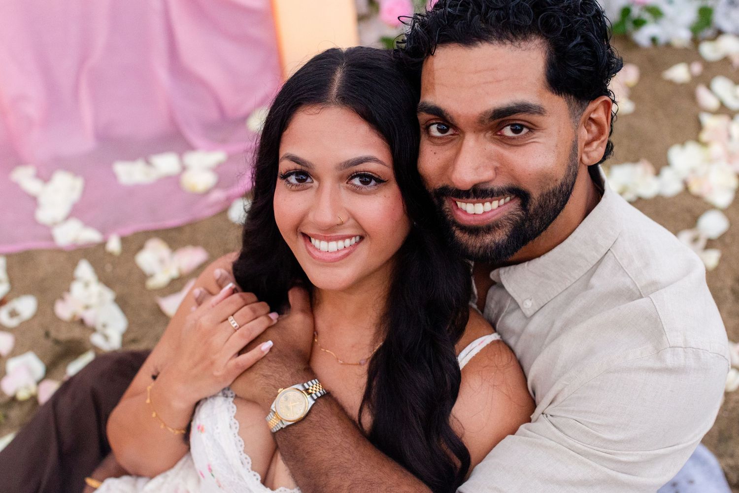 Close-up engagement portrait on the beach. Man and woman with candles and flowers. Playa Guajataca, Isabela, Puerto Rico.