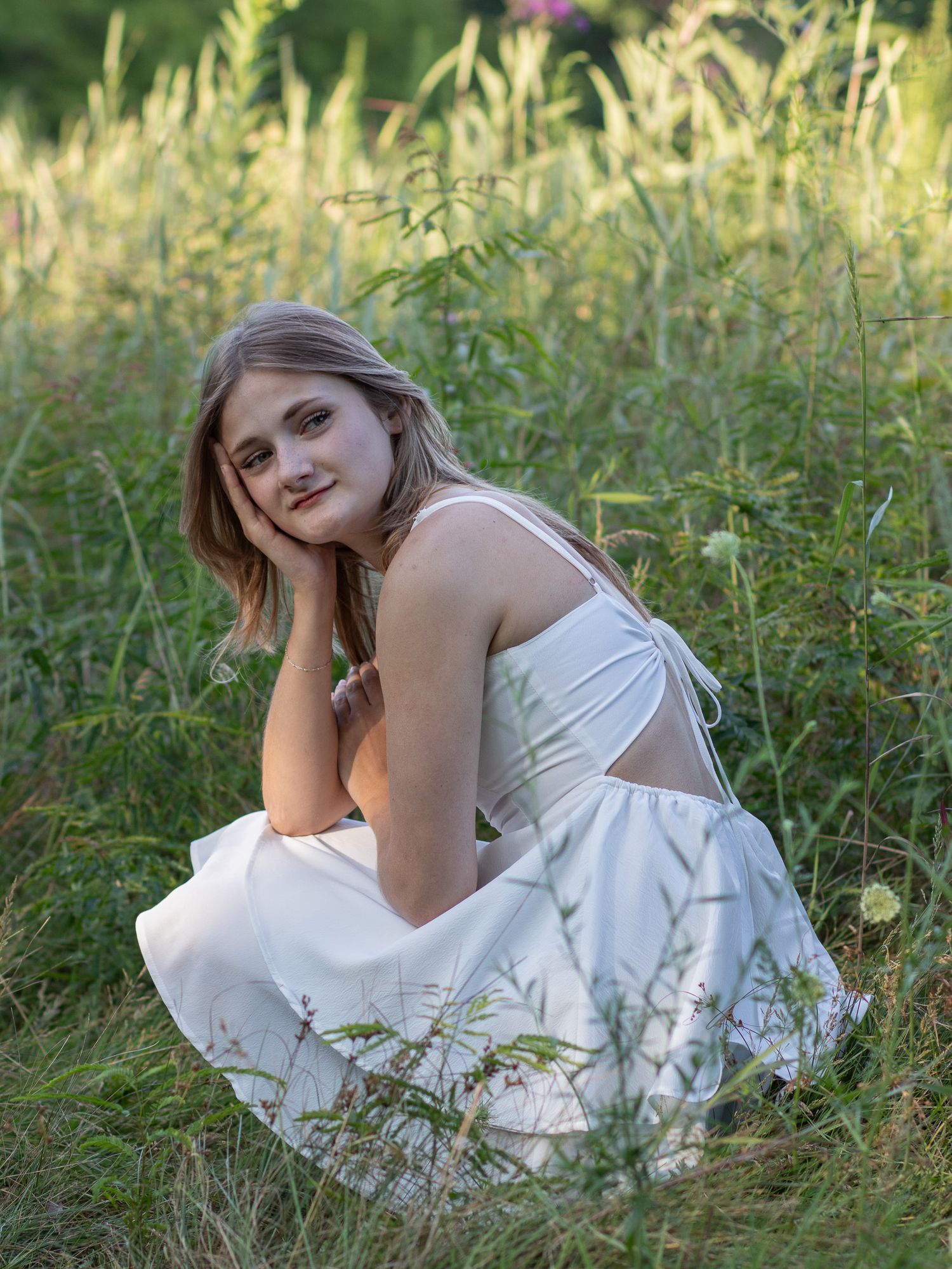 Senior blonde girl posing at the Meadow at Huntington Reservation in Bay Village, Ohio. Bay Village senior photographer.
