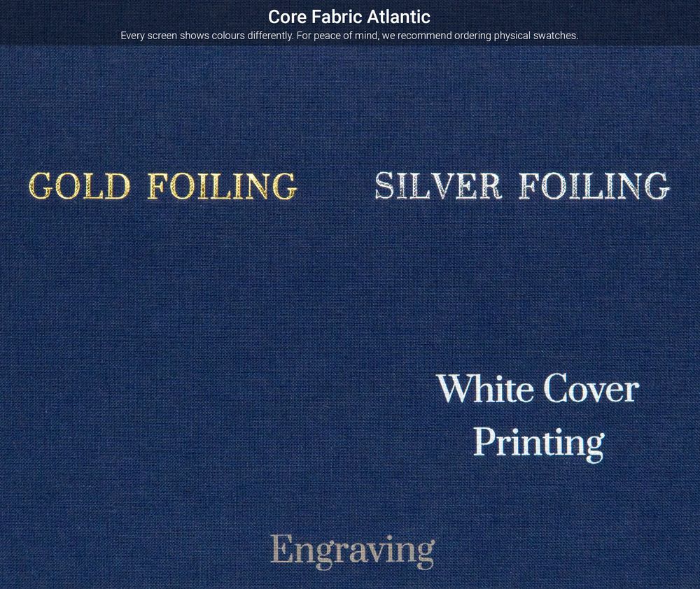 Close-up view of metallic text showing 'Core Fabric Atlantic' with engraving and foiling details on a dark blue background.