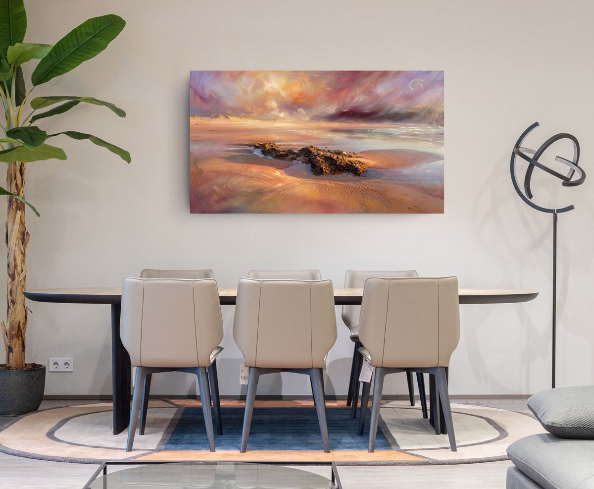 Modern dining room with oval table, beige chairs, and a large abstract seascape painting in warm sunset tones on the wall.