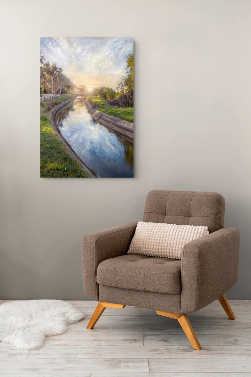 Brown armchair with pillow beside a fluffy rug, beneath a serene canal landscape painting in a modern living room.