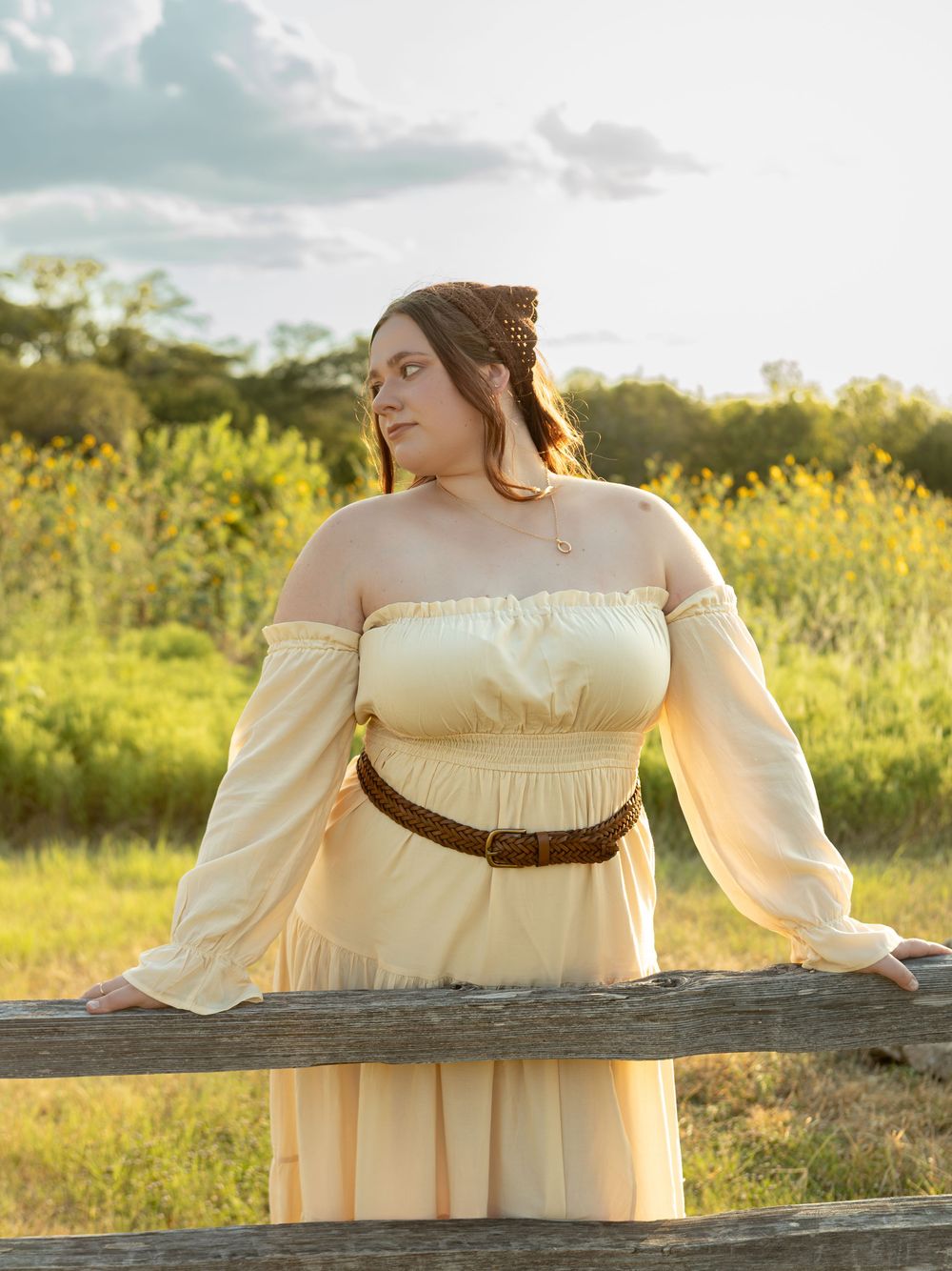 women leaning on fence in yellow dress at common ford ranch.