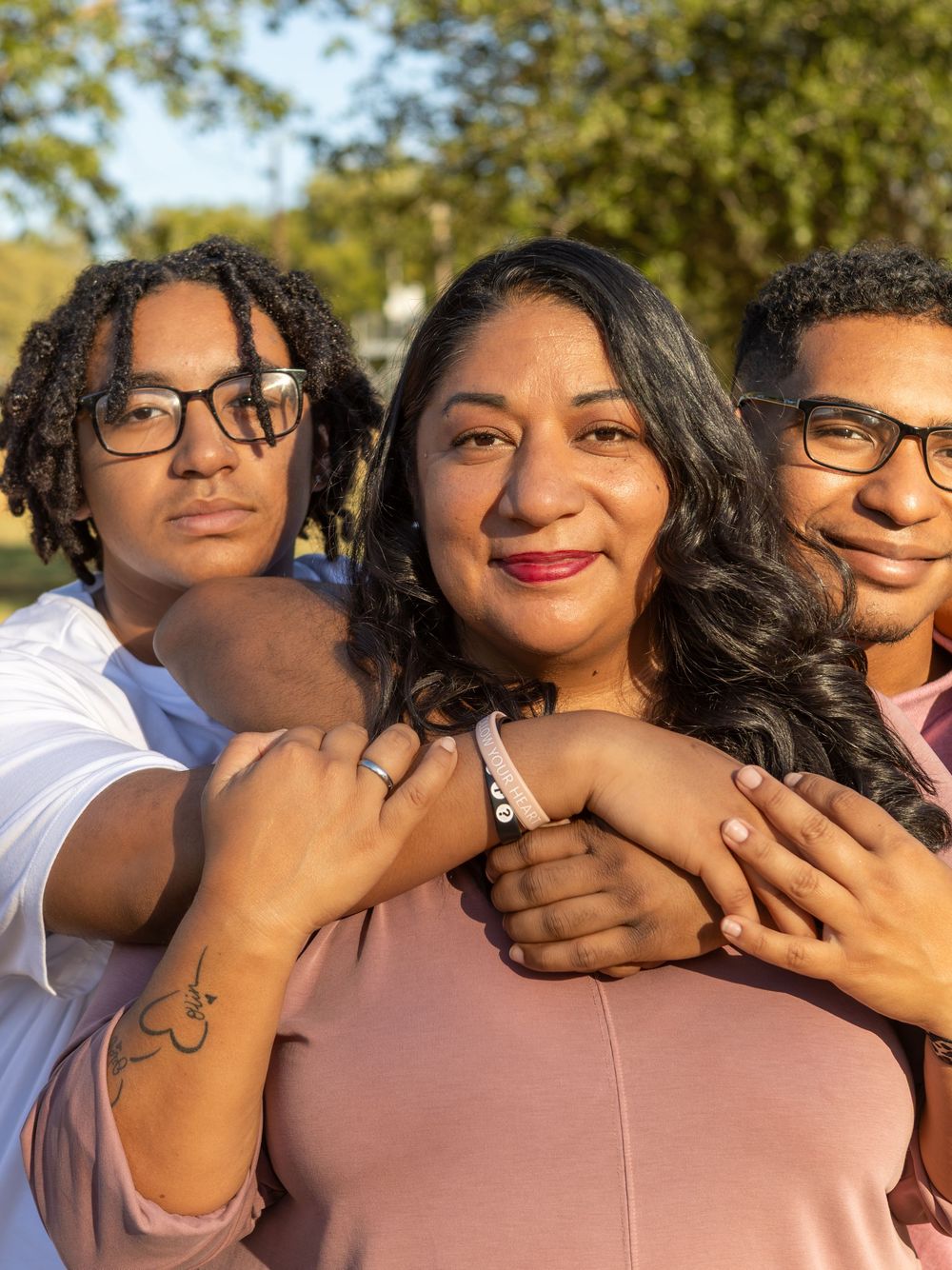 Mother And sons Hugging At Webberville Park.